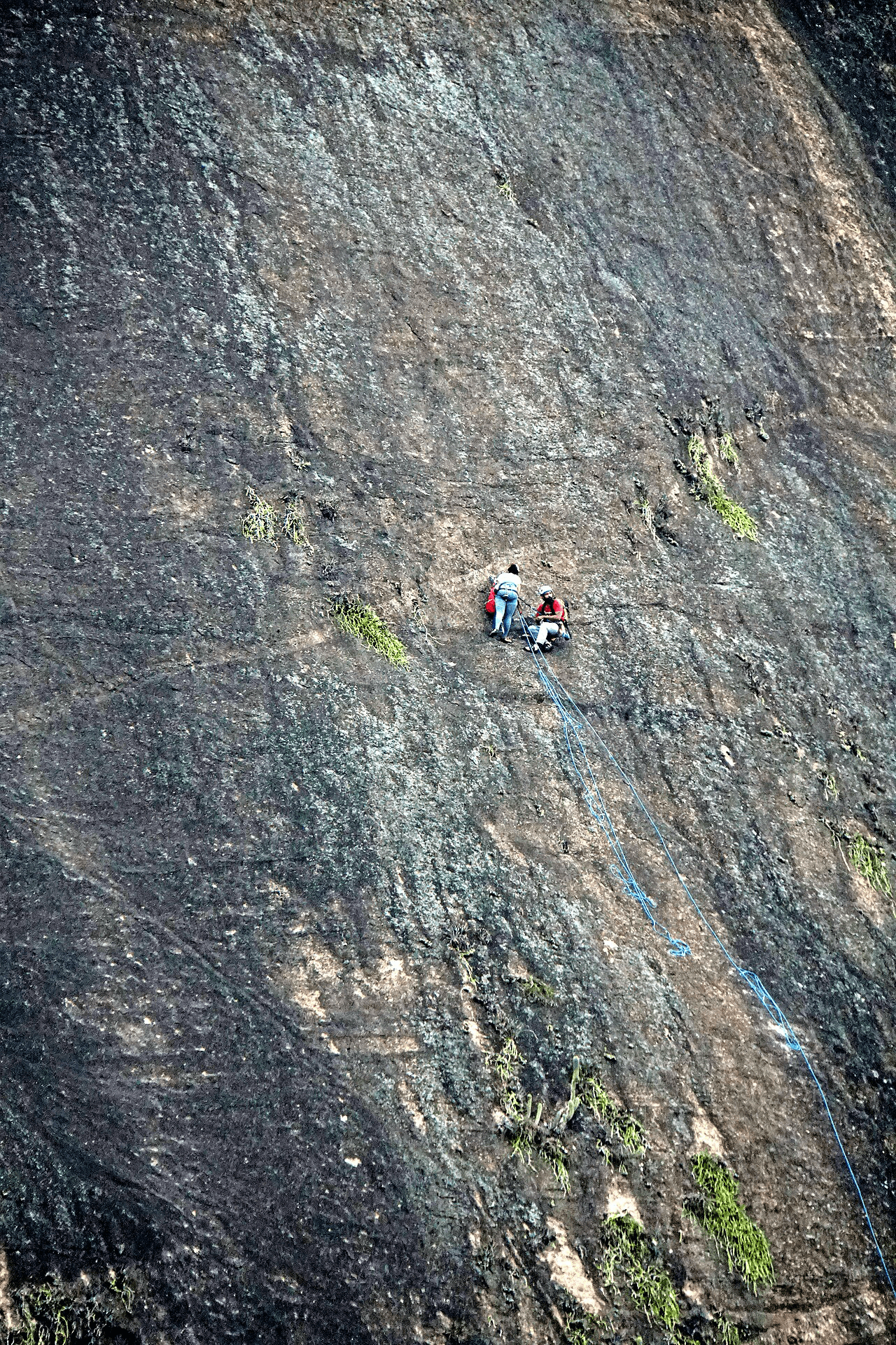Climber on Itatiaia granite face above the Atlantic Forest, Brazil